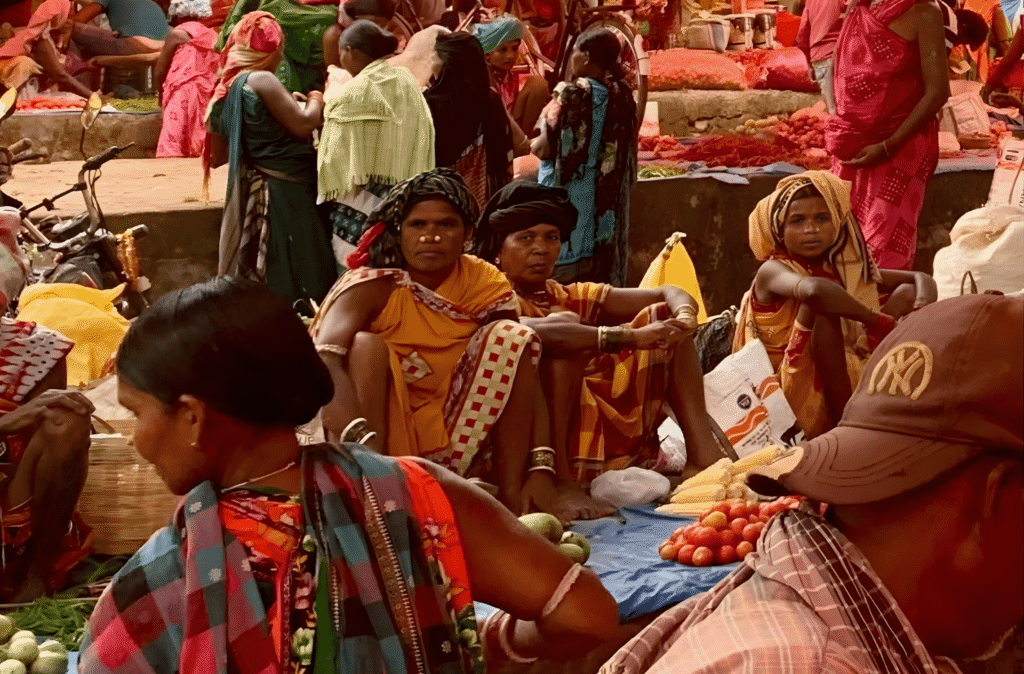 Exploring the Hidden Charms of Odisha: My Odisha Tribal Tour 4 Odisha tribal women selling fresh fruits and vegetables at a vibrant village market during our Odisha Tribal Tour