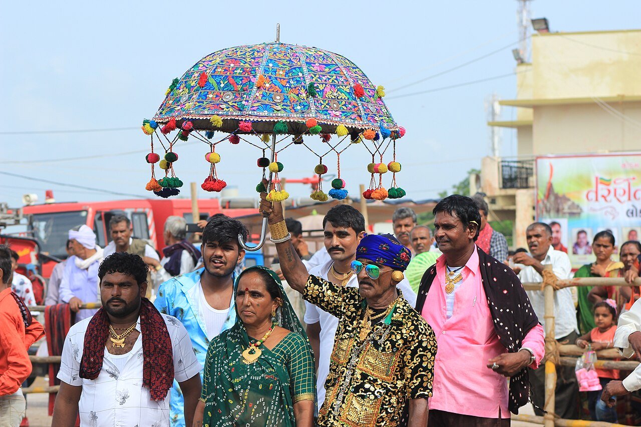 A man holds his embroidered umbrella
