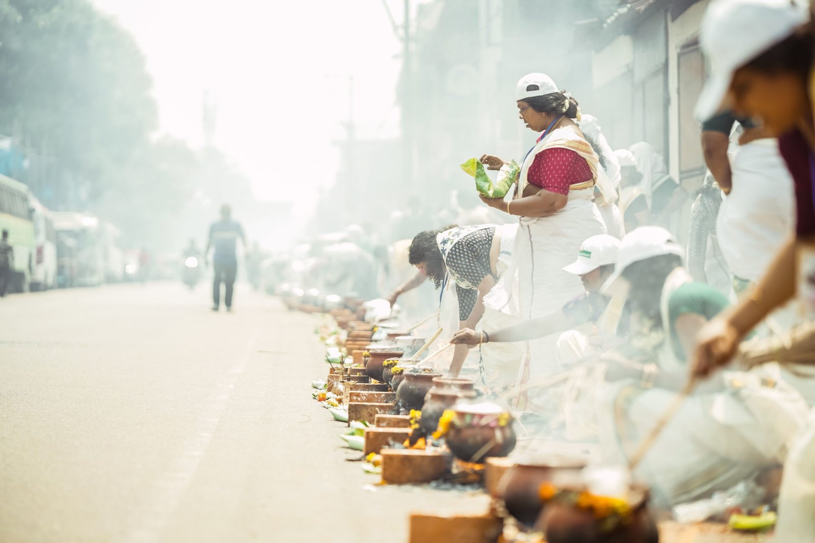 Women cooking pongala over rows of brick stoves at the Attukal Pongala festival in Kerala - Real Indian Food | A guide by Immerse India Tours
