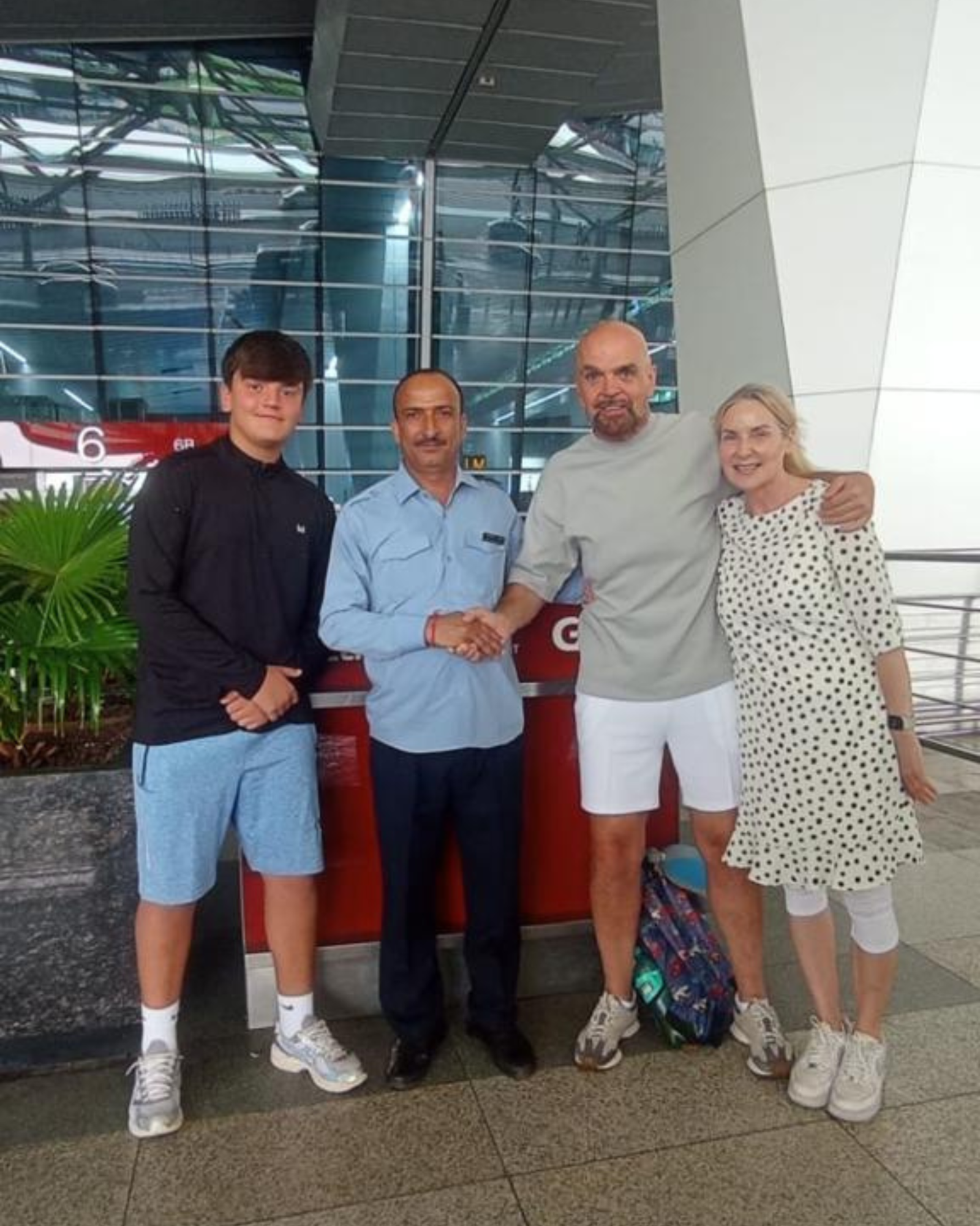Driver and guest saying goodbye at the airport after travelling in India together